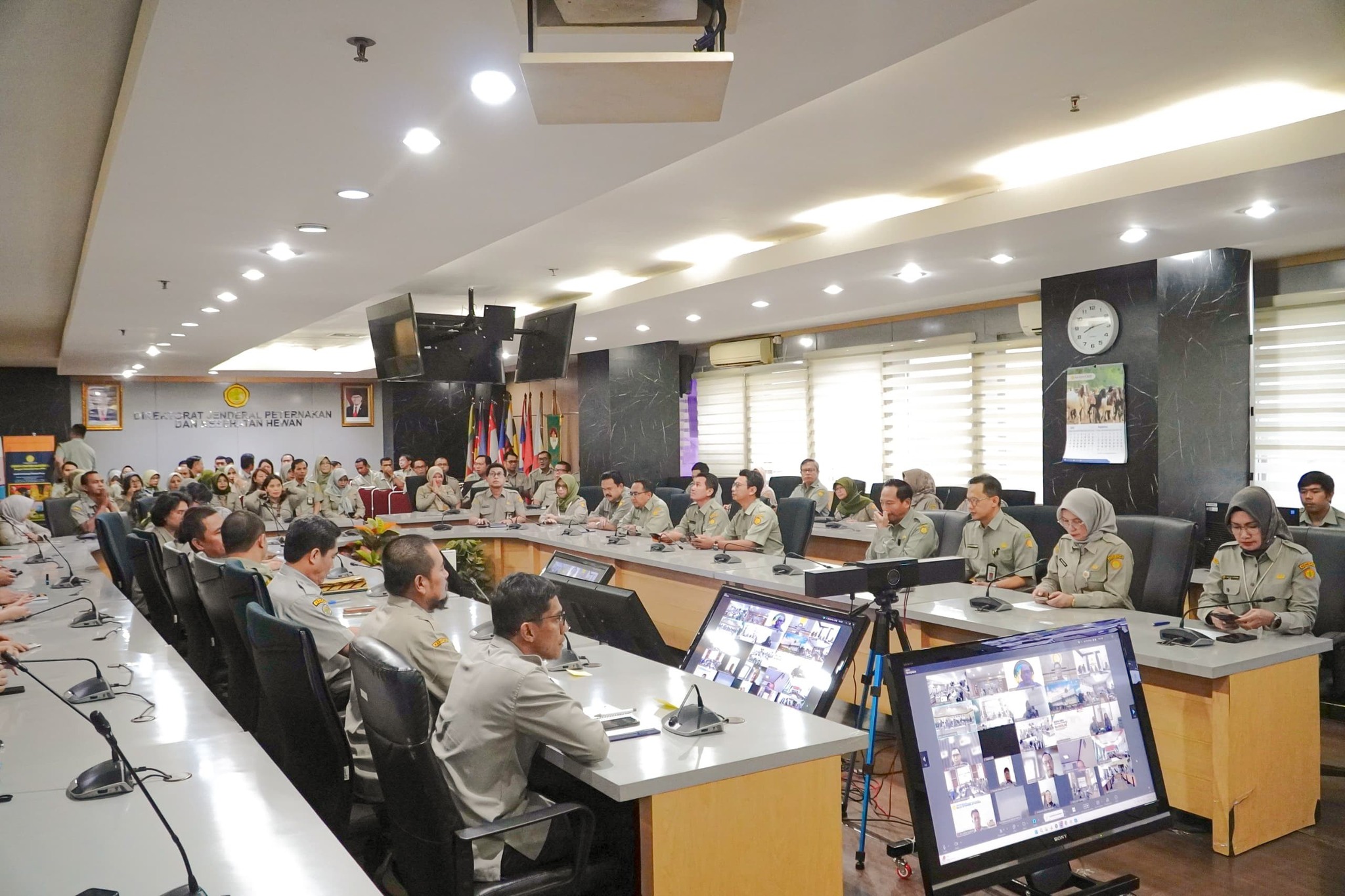 May be an image of 9 people, people studying, newsroom and text